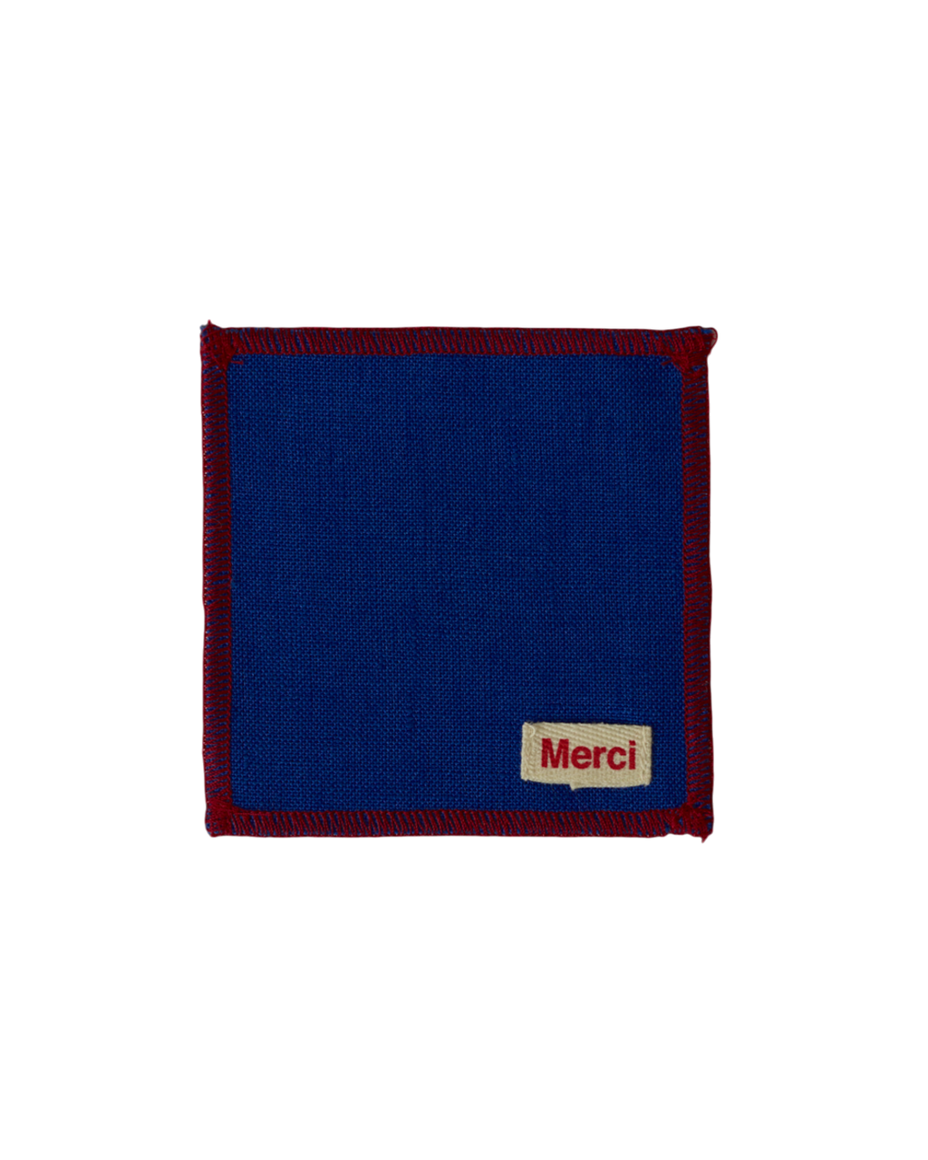Dessous de verre carré en lin lavé bleu cobalt avec bordure contrastante rouge, signé Merci Paris