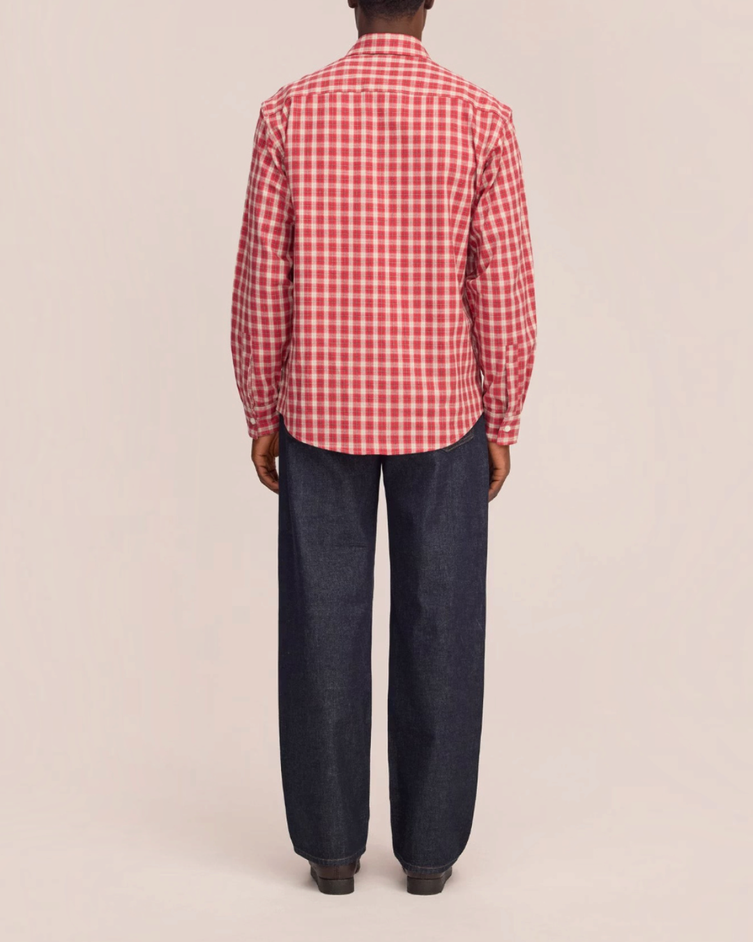 Vue arrière d'un homme portant la chemise à carreaux rouges NN.07 en flanelle de coton biologique de Merci Paris