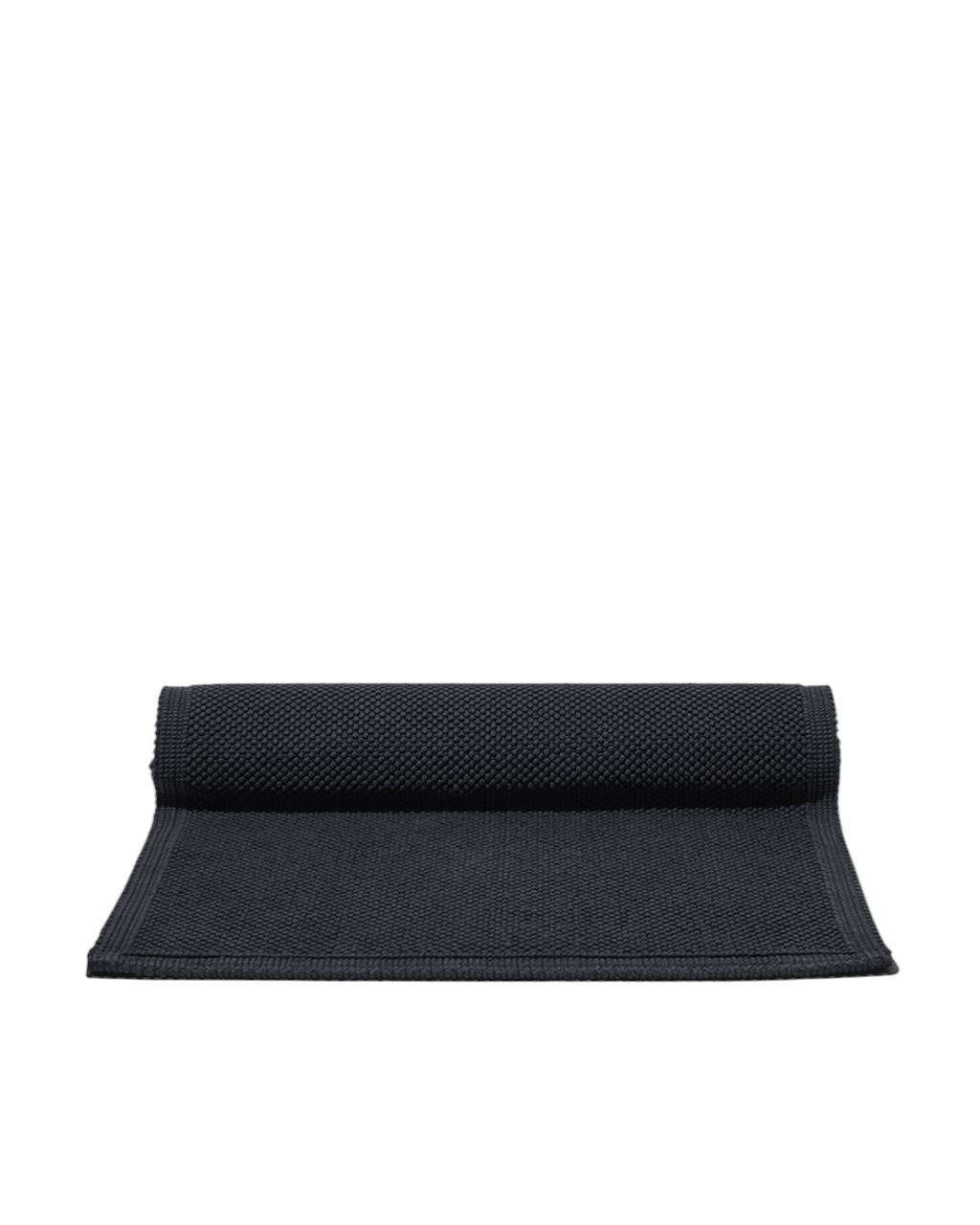 Tapis de bain Vivaraise couleur carbone à texture grainée, proposé par Merci Paris pour une salle de bain élégante.