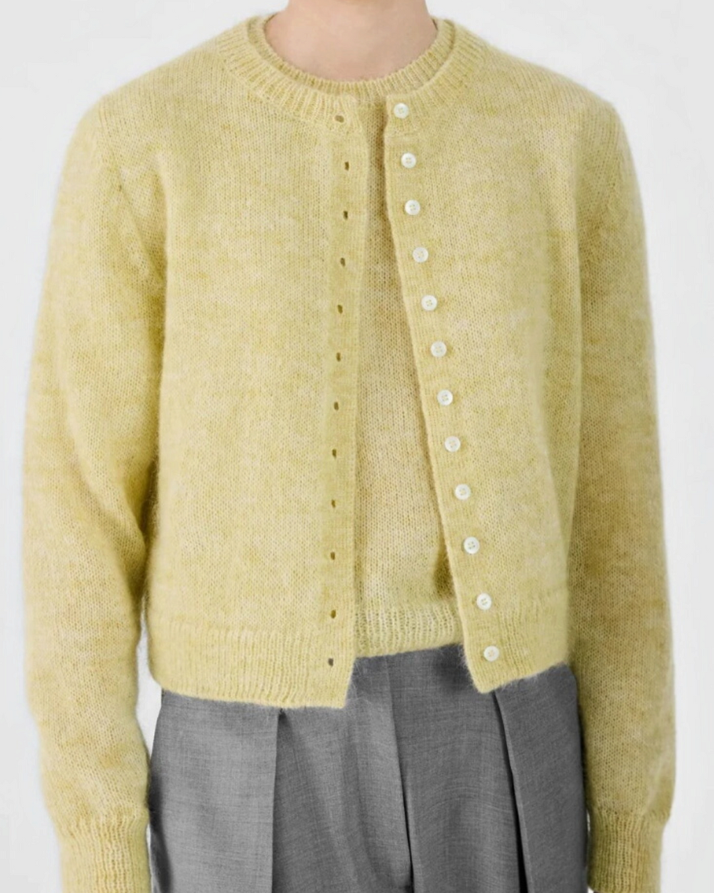 Cropped cardigan Merci Paris in lemon yellow fluffy knit, blend of mohair and wool, worn by a model