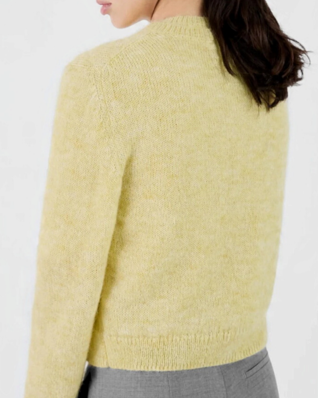 Short cardigan Merci Paris Masscob in lemon yellow fluffy knit, worn by a woman seen from behind