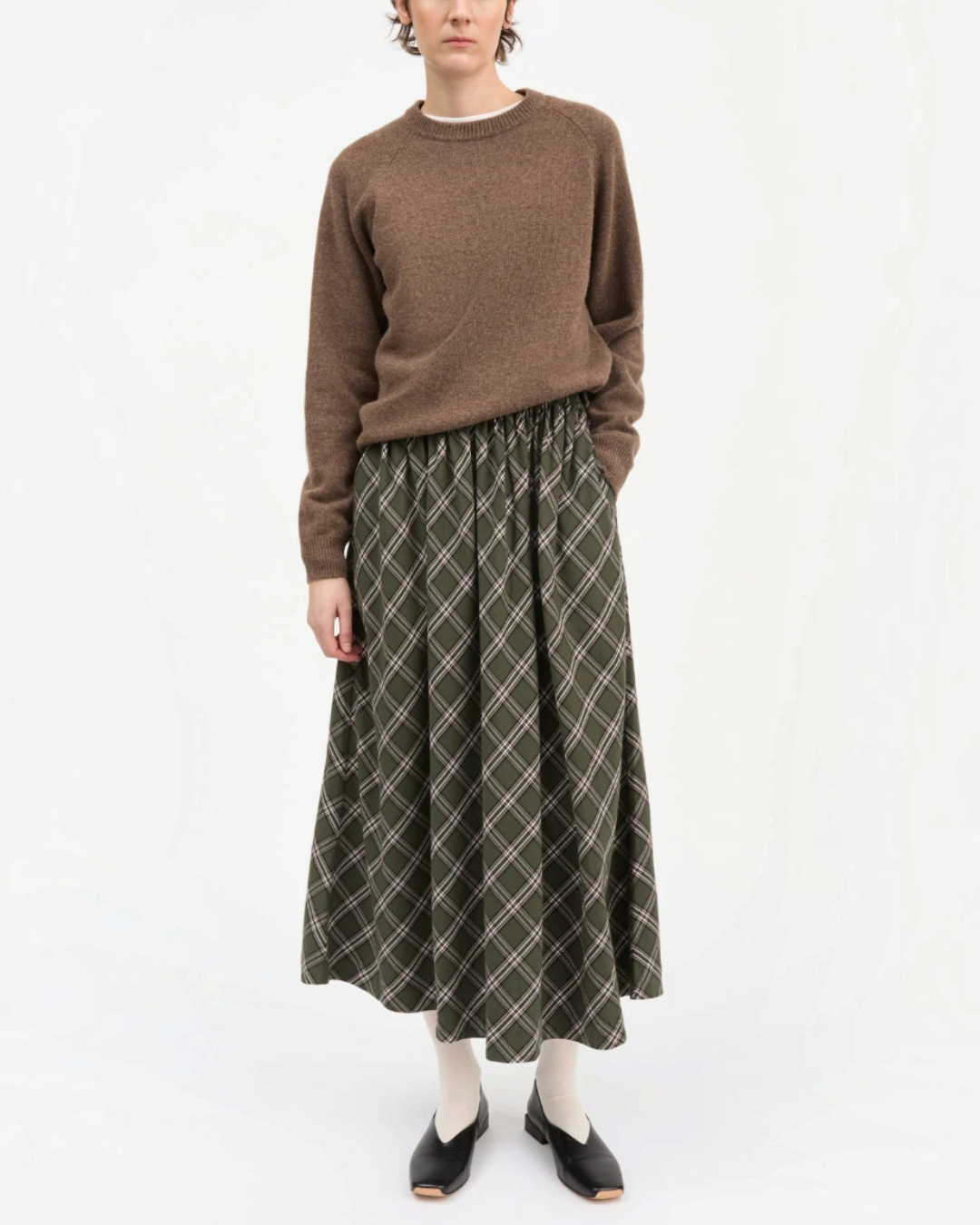 Model wearing the green and white checked Dagny skirt by Merci Paris in organic cotton with elastic waist