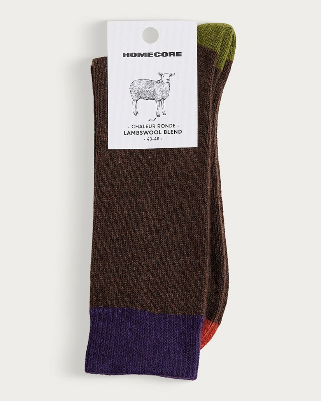 Chaussettes Homecore en laine d'agneau marron avec détails colorés, présentées sur leur étiquette Merci Paris