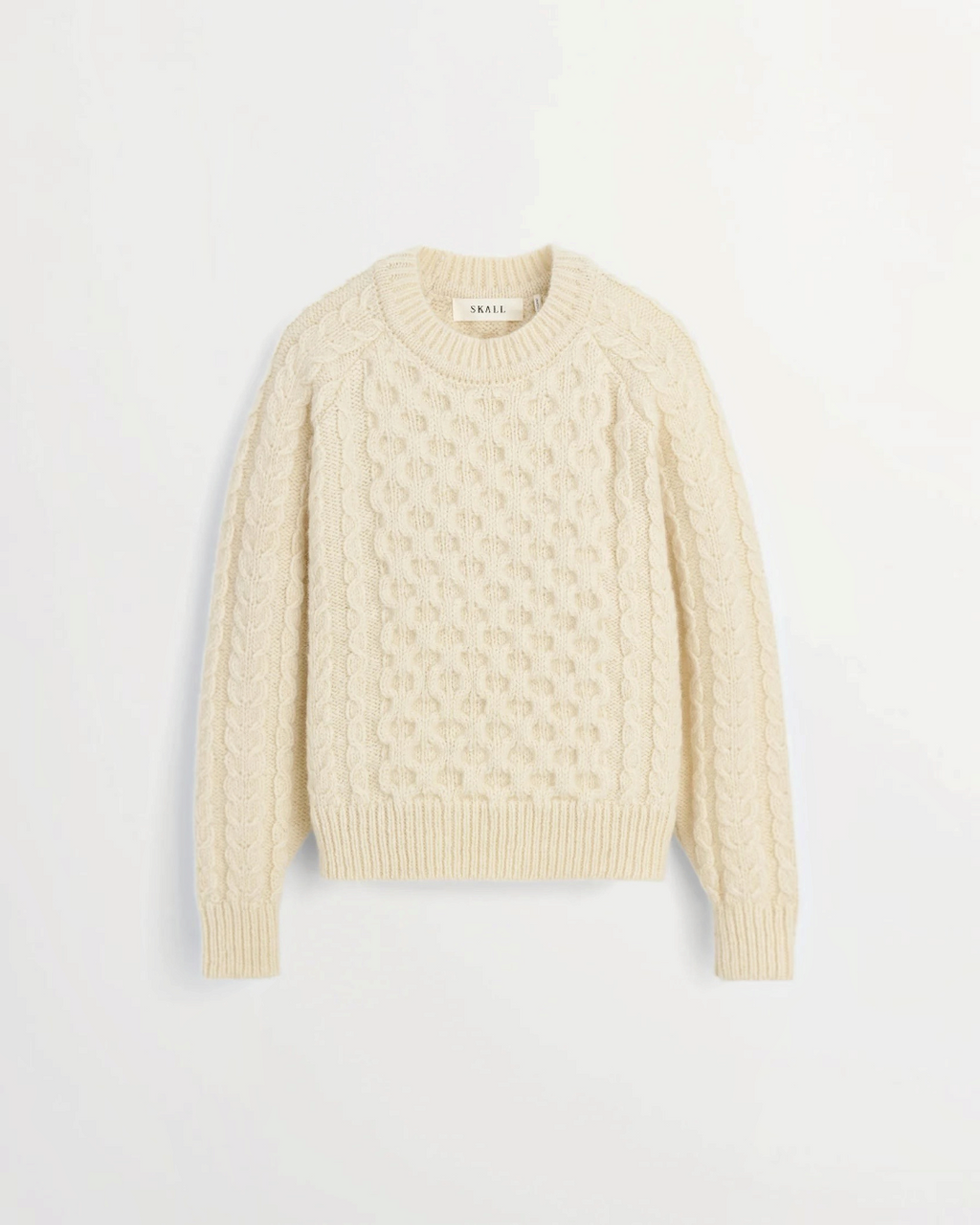 Pull Lennox blanc en laine à maille torsadée de la marque Merci Paris, avec manches raglan et col rond.