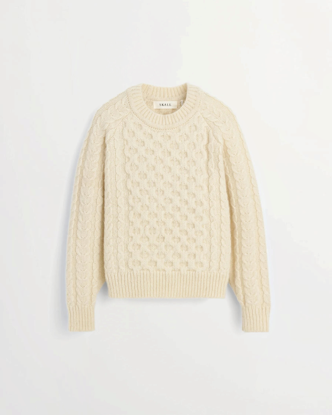 White Lennox sweater in cable knit wool from the brand Merci Paris, with raglan sleeves and round neck.
