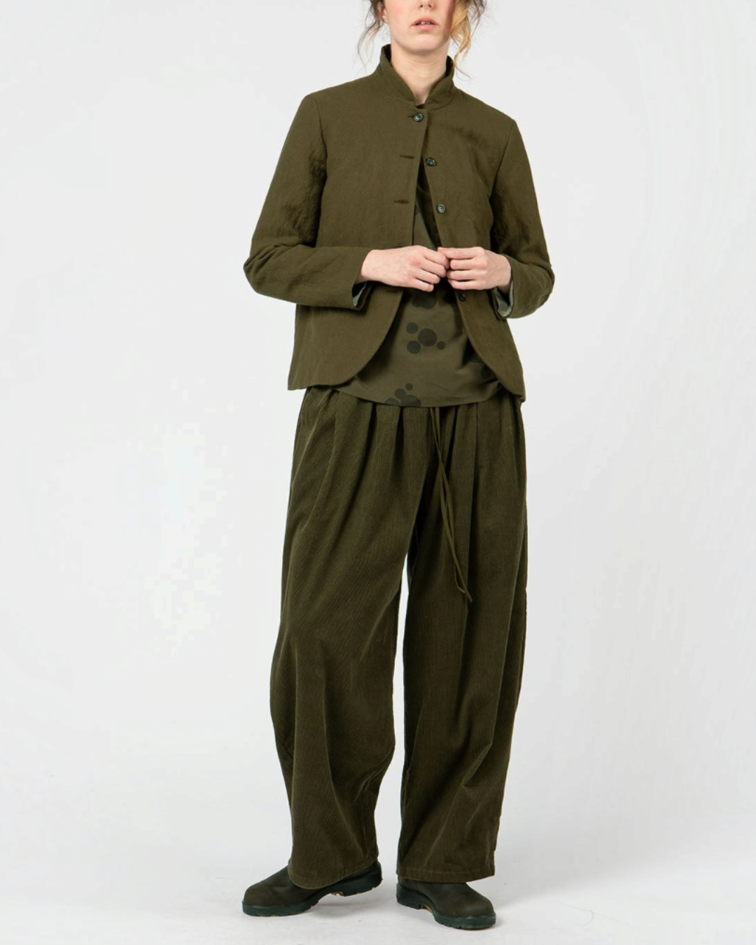 Modèle portant une veste courte Merci Paris Apuntob vert militaire à col montant et boutons ton sur ton