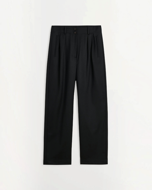 Pantalon large noir Skall Studio en laine avec taille semi-haute et plis, disponible chez Merci Paris